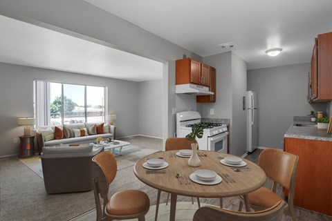 A modern kitchen with a dining table set for two.