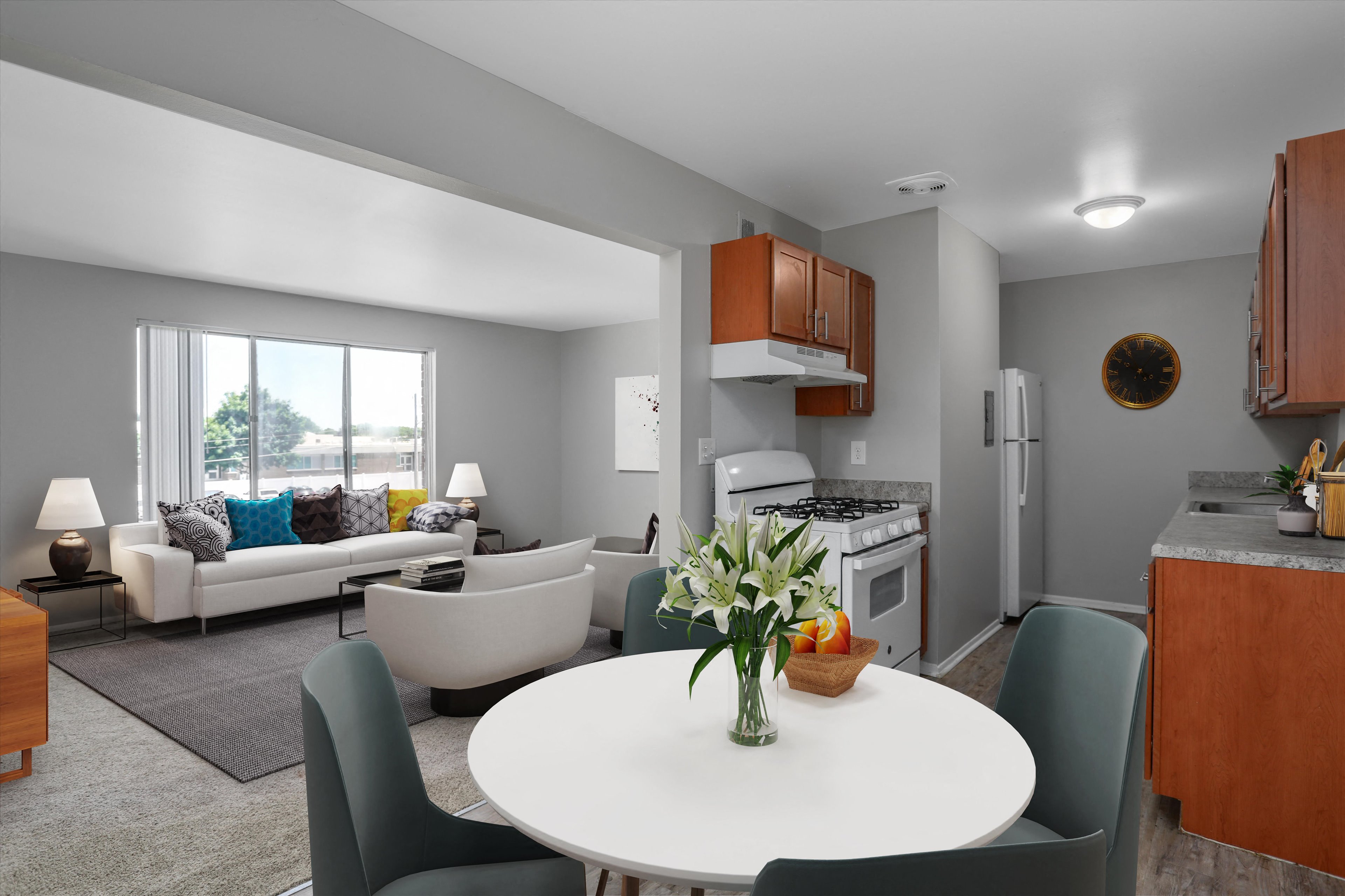 A modern kitchen with a dining table set in the middle.