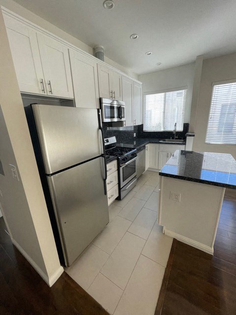 a kitchen with stainless steel appliances and white cabinets