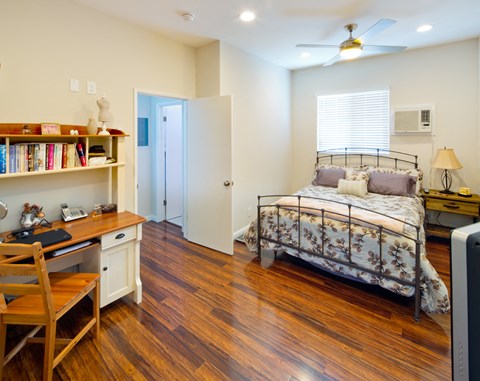 a bedroom with a bed and a desk