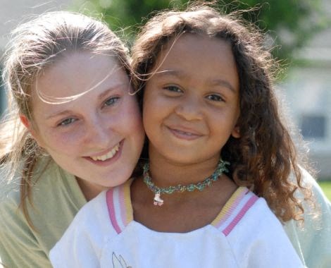 a woman and a young girl pose for a picture