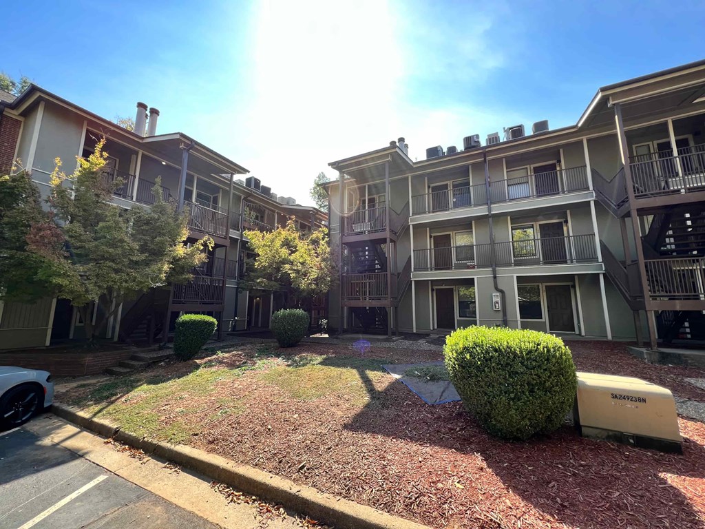 an apartment building with a small yard in front of it
