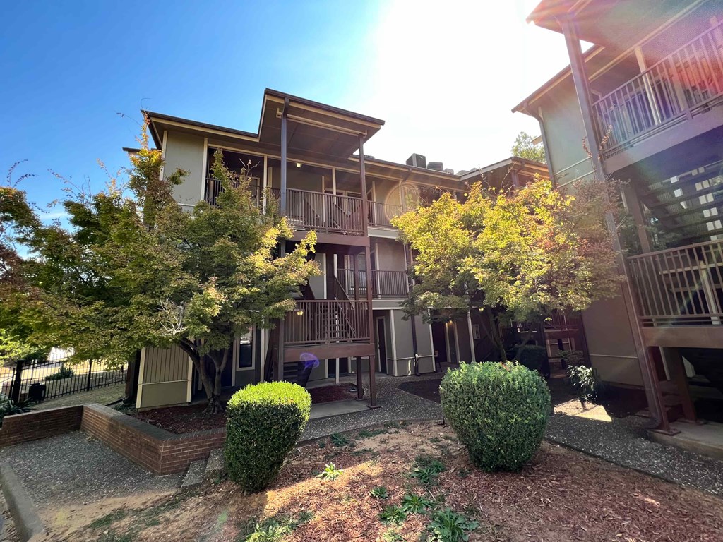 an exterior view of a building with trees and shrubs