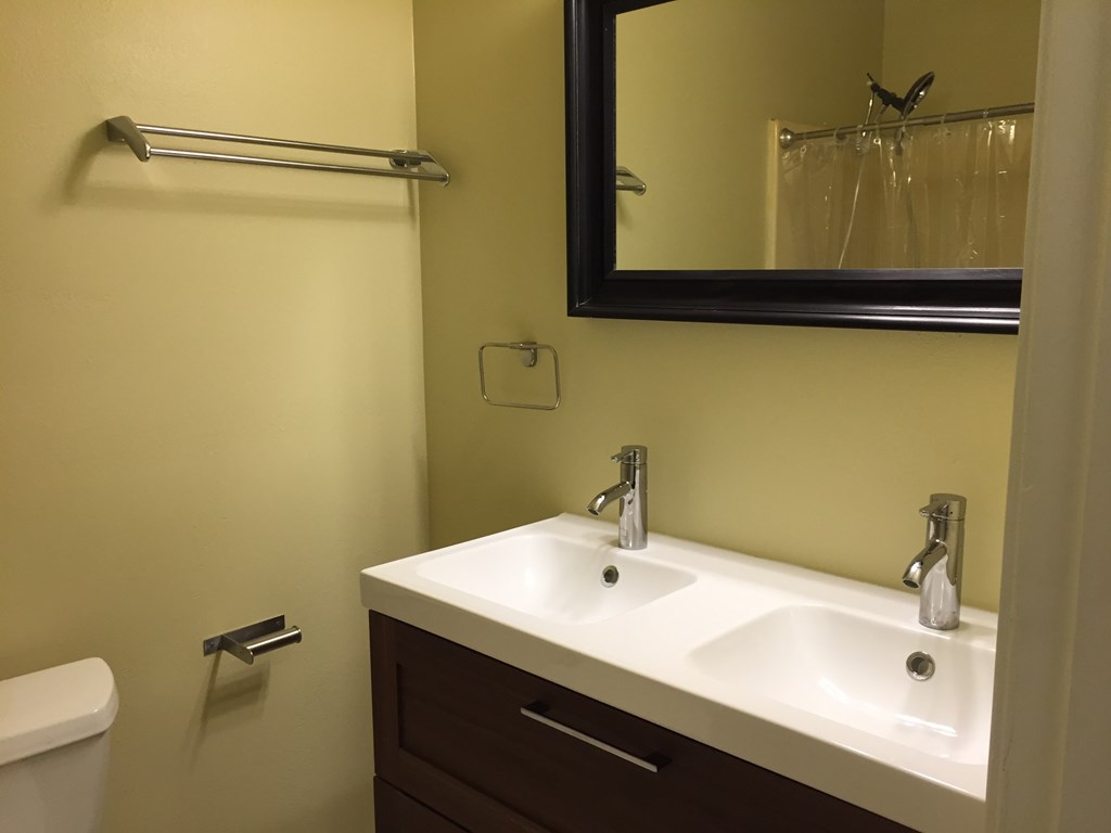 a bathroom with a white sink and a mirror