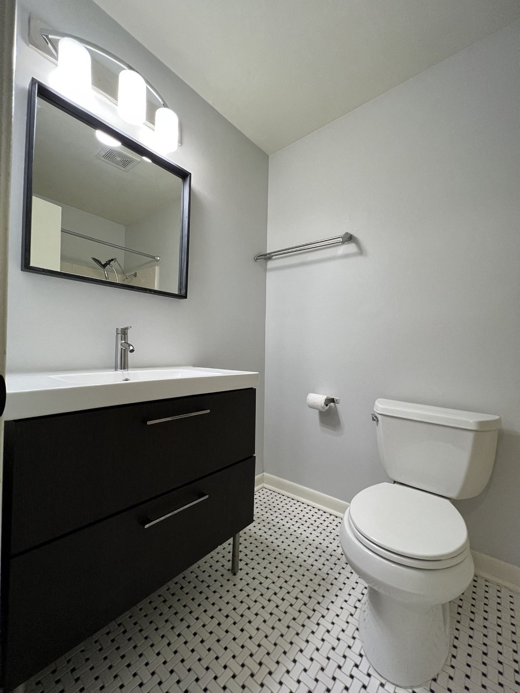 a bathroom with a toilet and a sink and a mirror