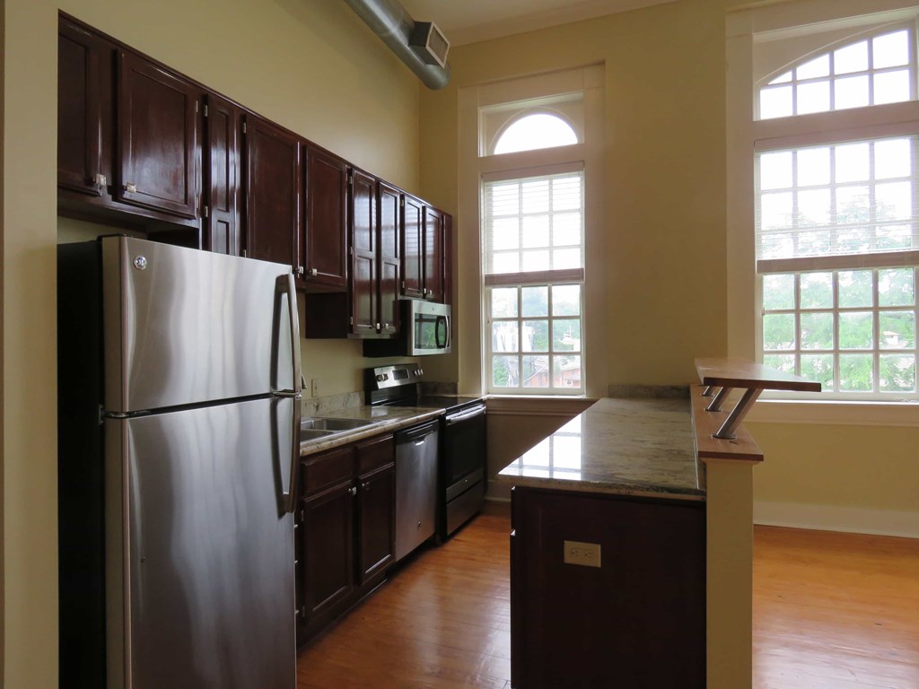 a kitchen with stainless steel appliances and wooden cabinets