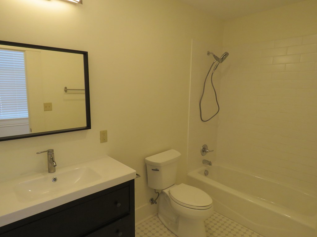 a bathroom with a sink toilet and a bath tub