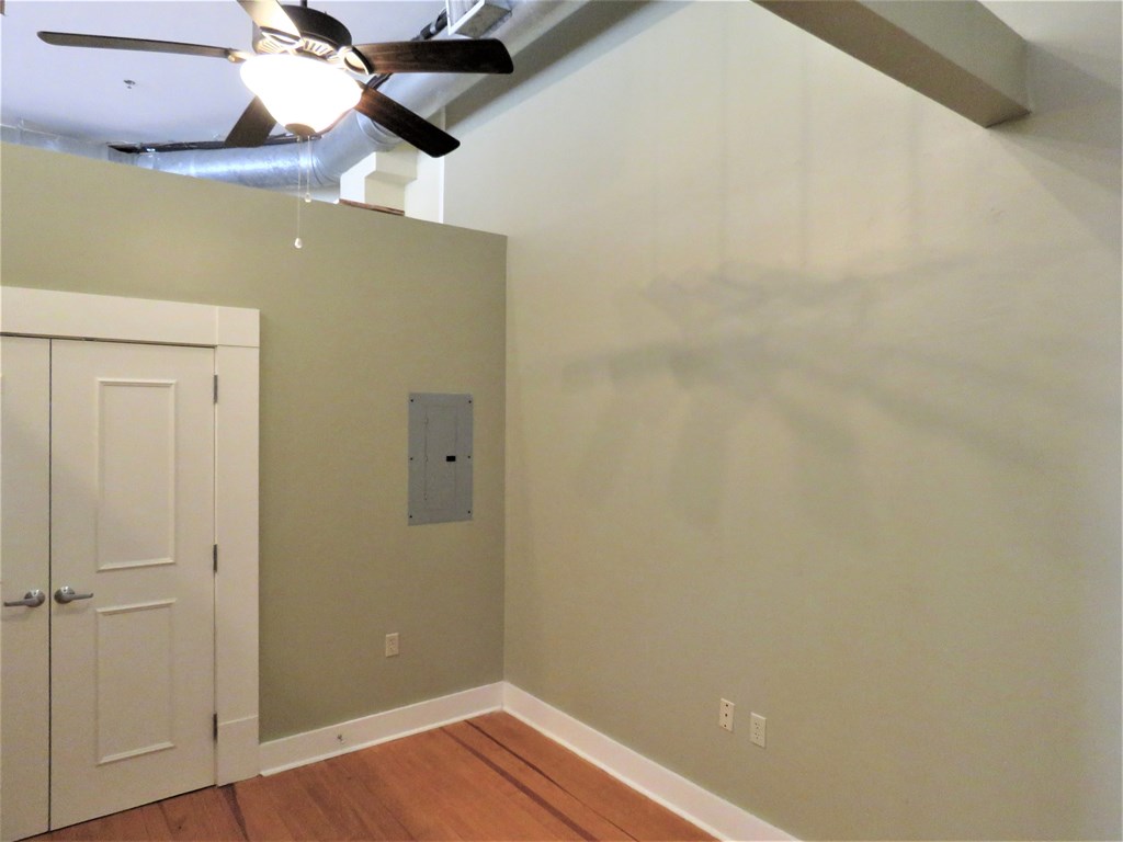 a bedroom with a closet and a ceiling fan