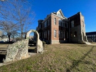 an old brick house with a stone arch in front of it