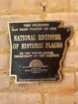 a sign on the side of a brick building