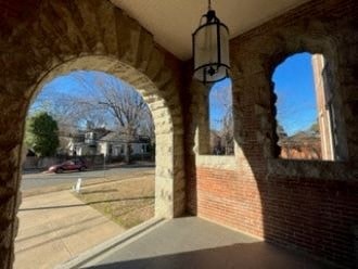 the archways of a brick building overlooking a street