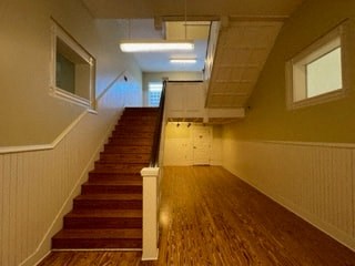 a large hall with stairs and a wood floor