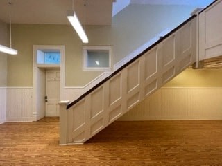 an empty room with a staircase and a door