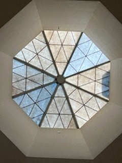 the triangular window in the ceiling of a room with triangular windows