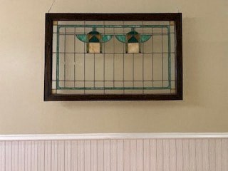 a mirror hanging on a wall above a white wall