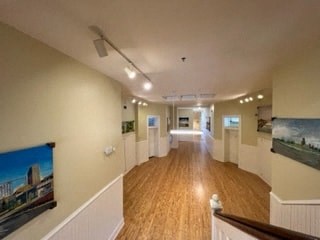 a large room with a wooden floor and white walls