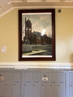 a picture hanging on a wall above some cabinets