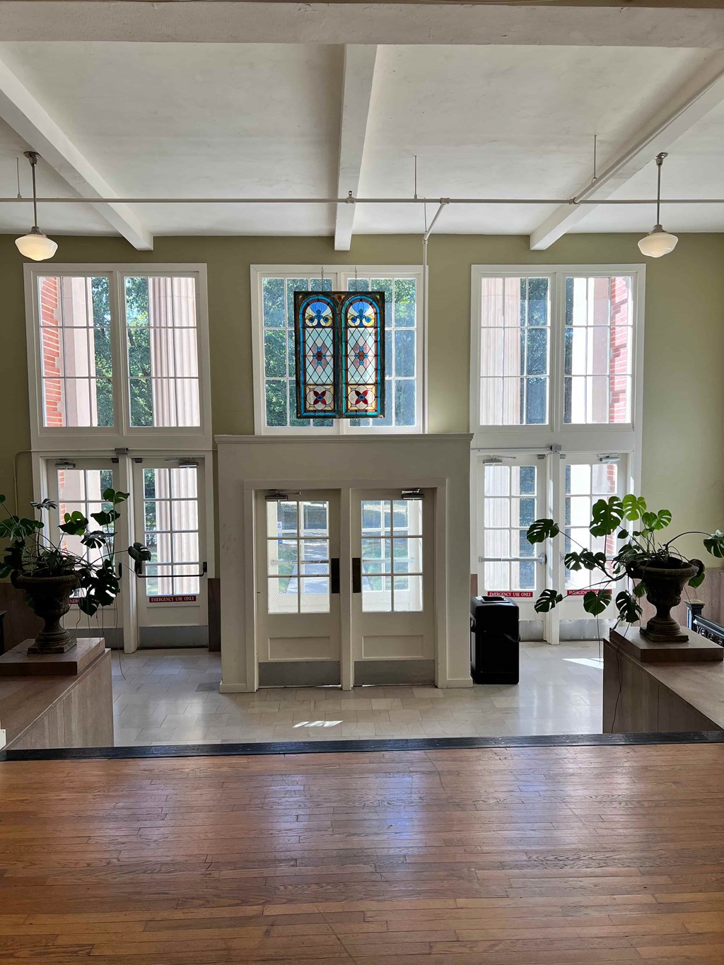 a large room with many windows and a wooden floor