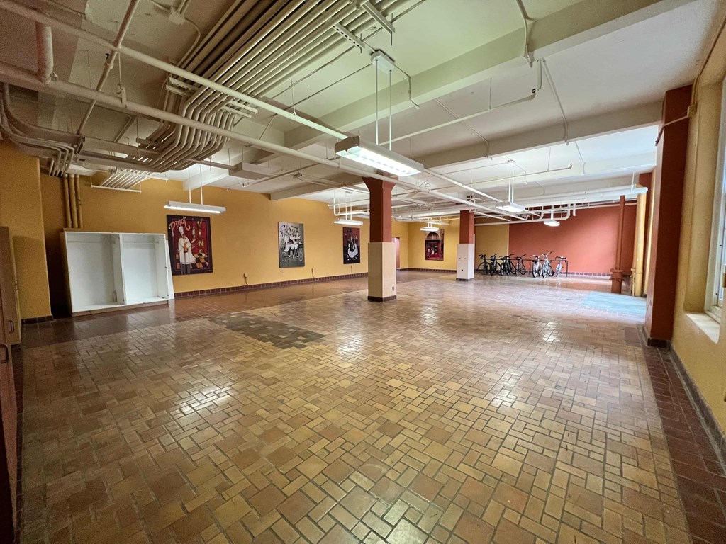 a large room with a tile floor in a hall