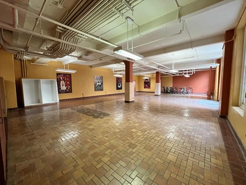 a large room with a tile floor in a hall