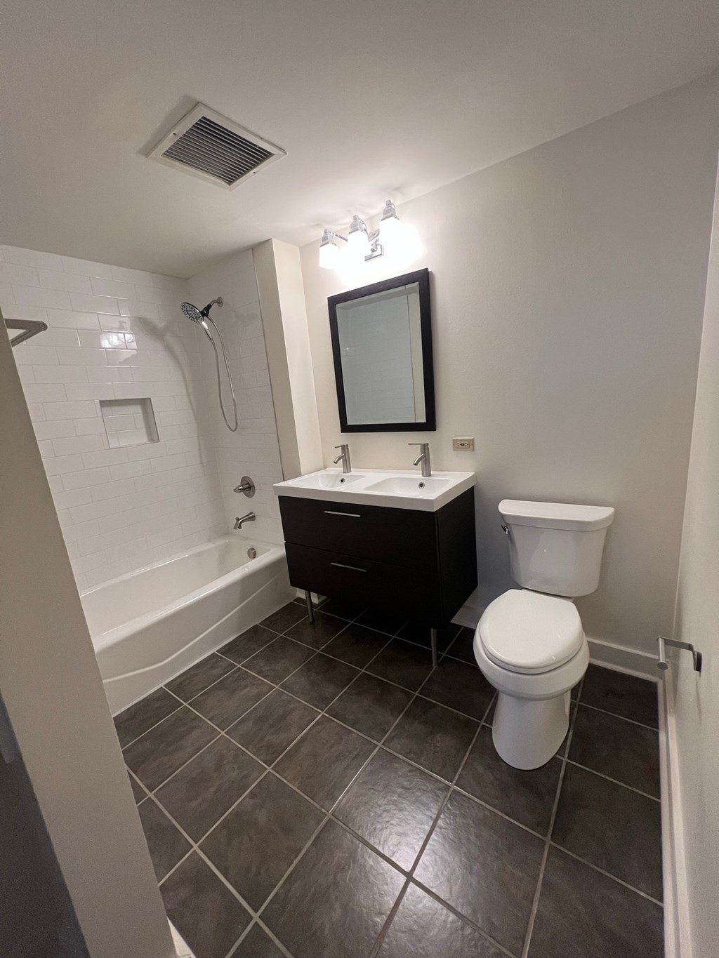 a bathroom with a toilet and a sink and a shower