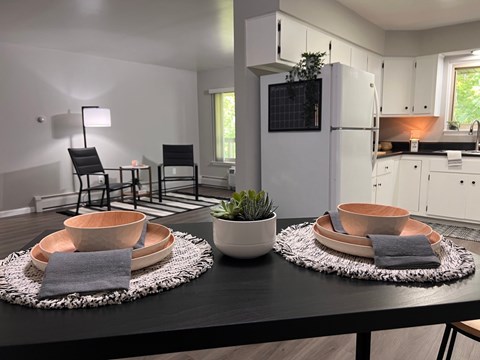 a kitchen and dining room with a table and chairs