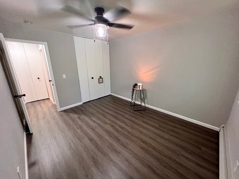A room with a ceiling fan and a light fixture.