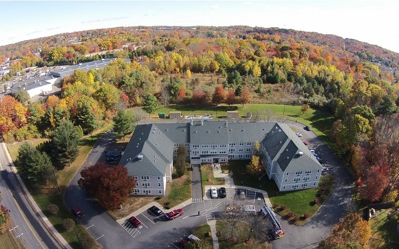 an aerial view of a building surrounded by trees