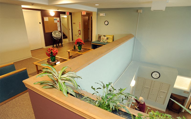a lobby with a reception desk and a clock on the wall