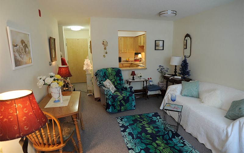 a living room filled with furniture and a bed
