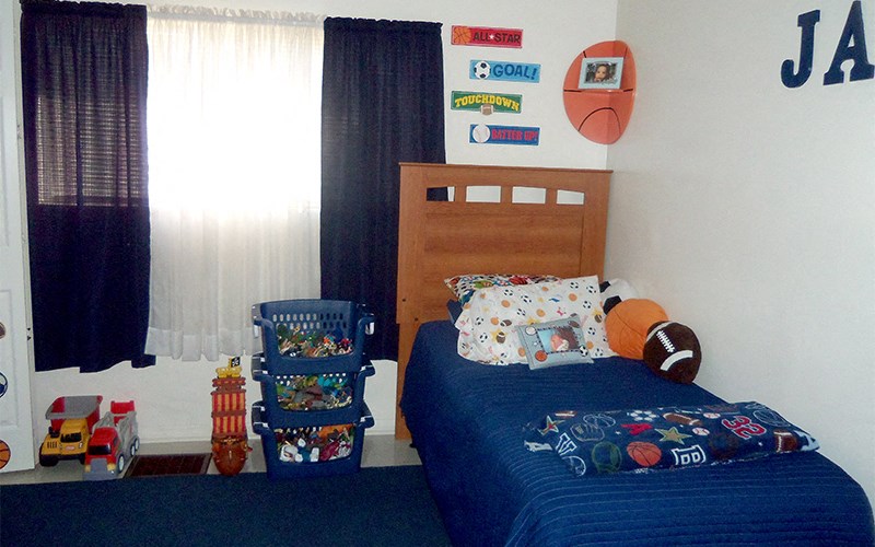 a boy s bedroom with a bed and a window