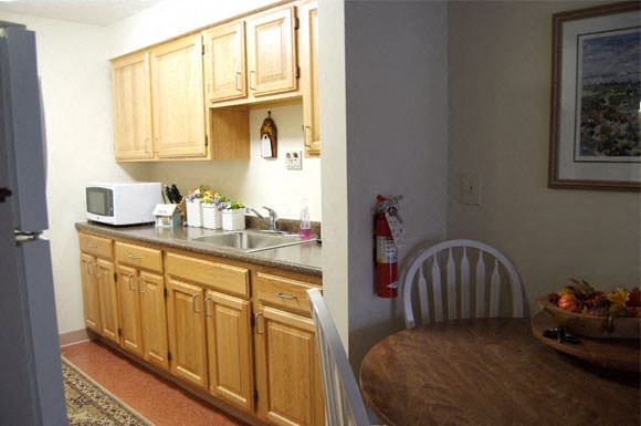 a kitchen with wooden cabinets and a table and a sink