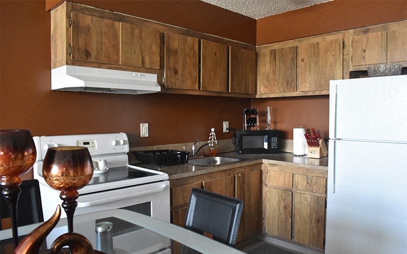 a kitchen with a stove refrigerator and sink