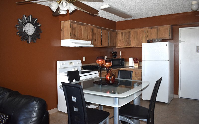 a kitchen and dining room with a table and a refrigerator