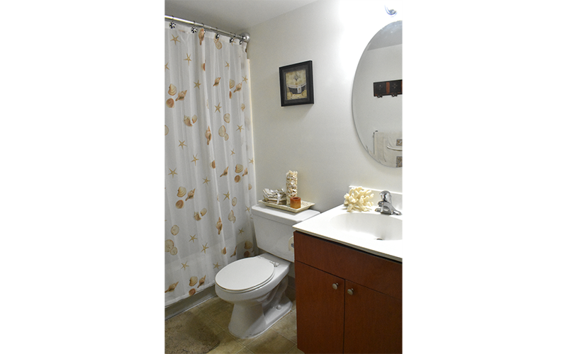 a bathroom with a toilet and a sink and a shower curtain