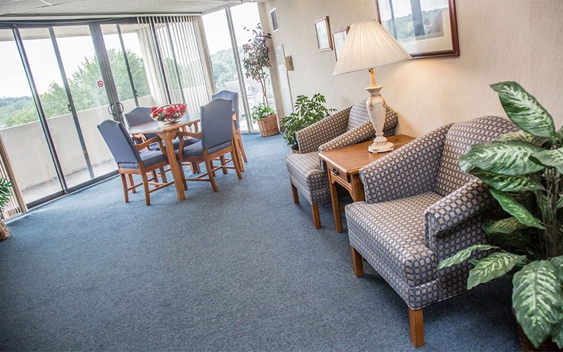 a living room with couches and chairs and a table