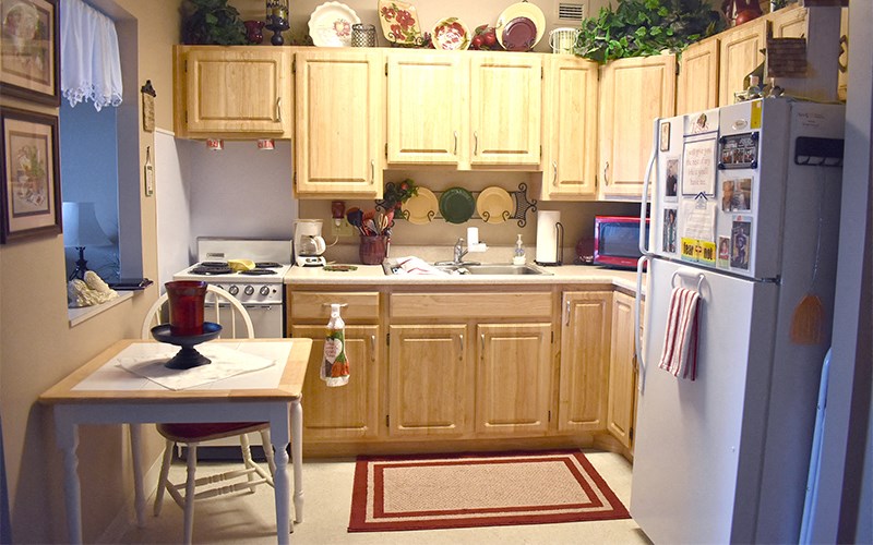 a kitchen with white appliances and wooden cabinets