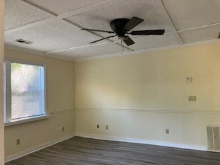 a living room with a ceiling fan and a window