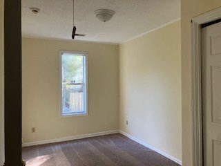 an empty living room with white walls and a window