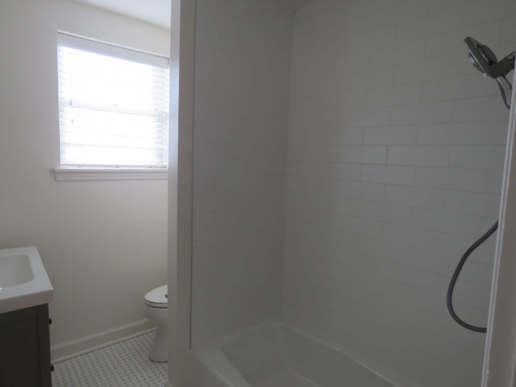 a small bathroom with a shower and a toilet