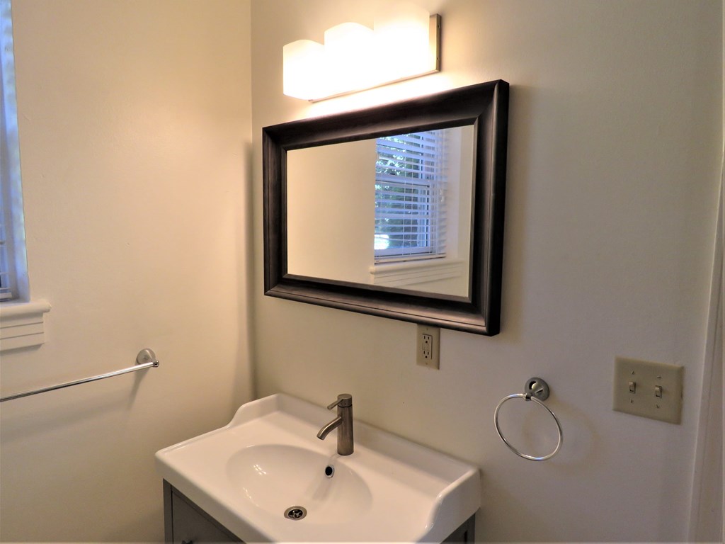 a small bathroom with a mirror and a sink