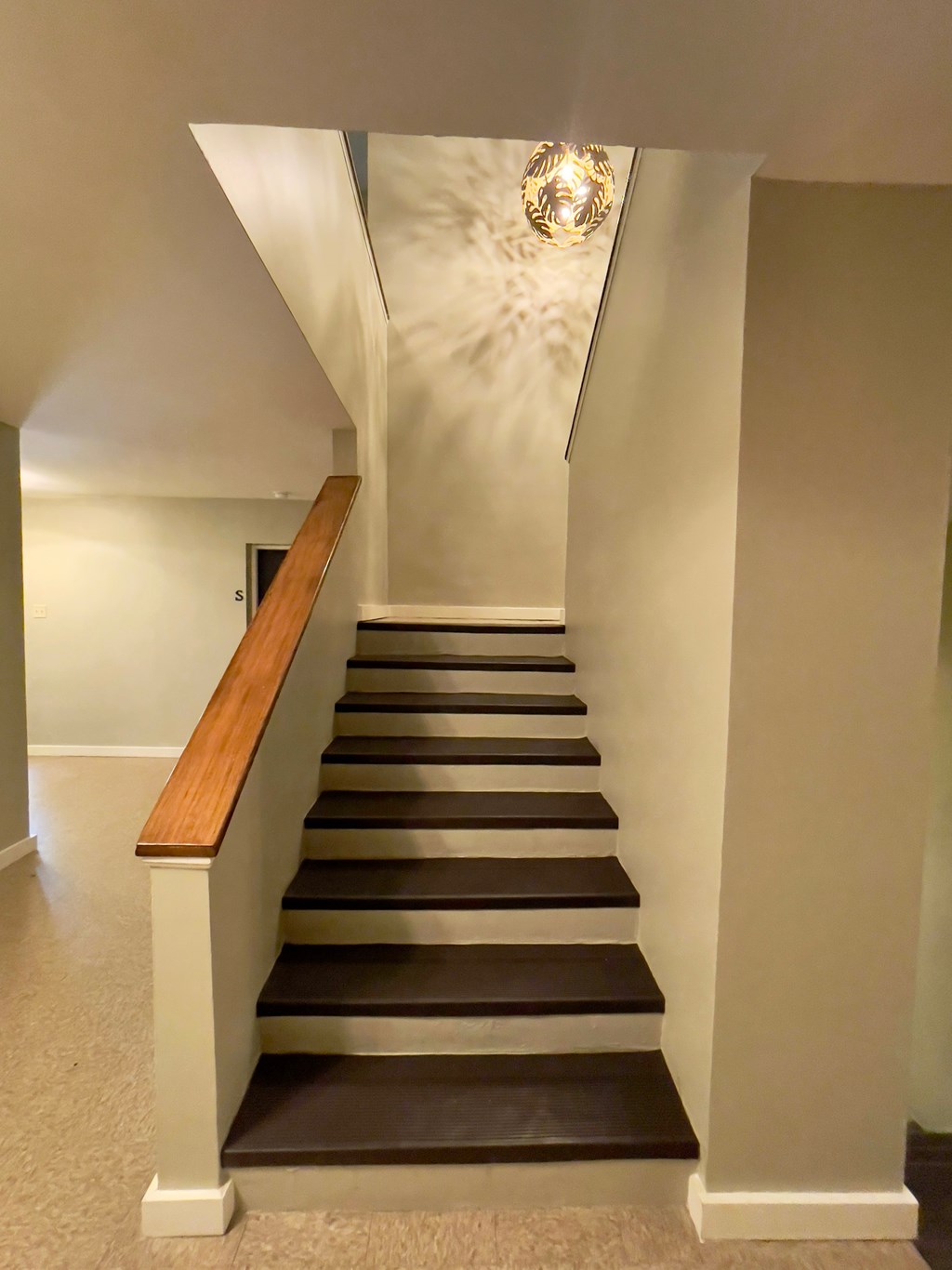 a set of stairs with a chandelier at the top