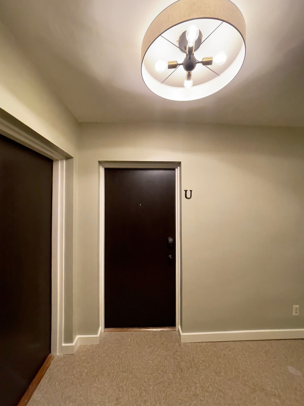 a hallway with a door to a closet and a ceiling fan