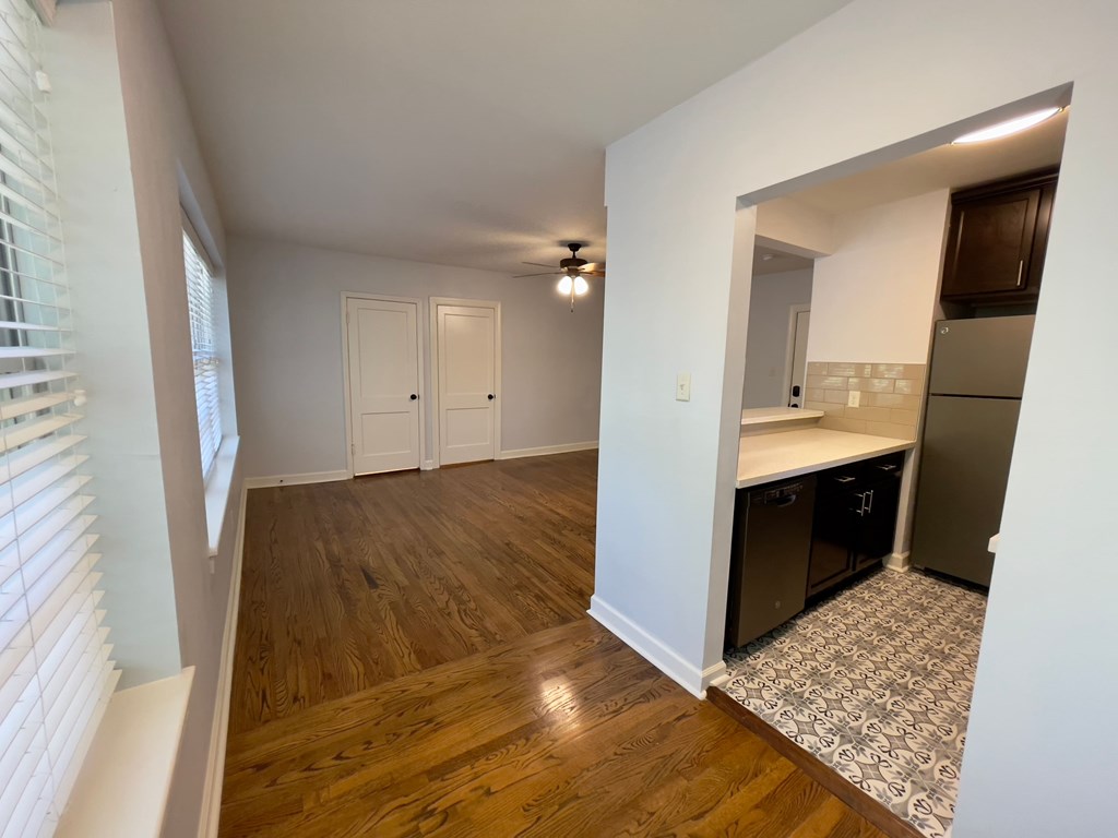 a kitchen and living room with wood flooring and a large window