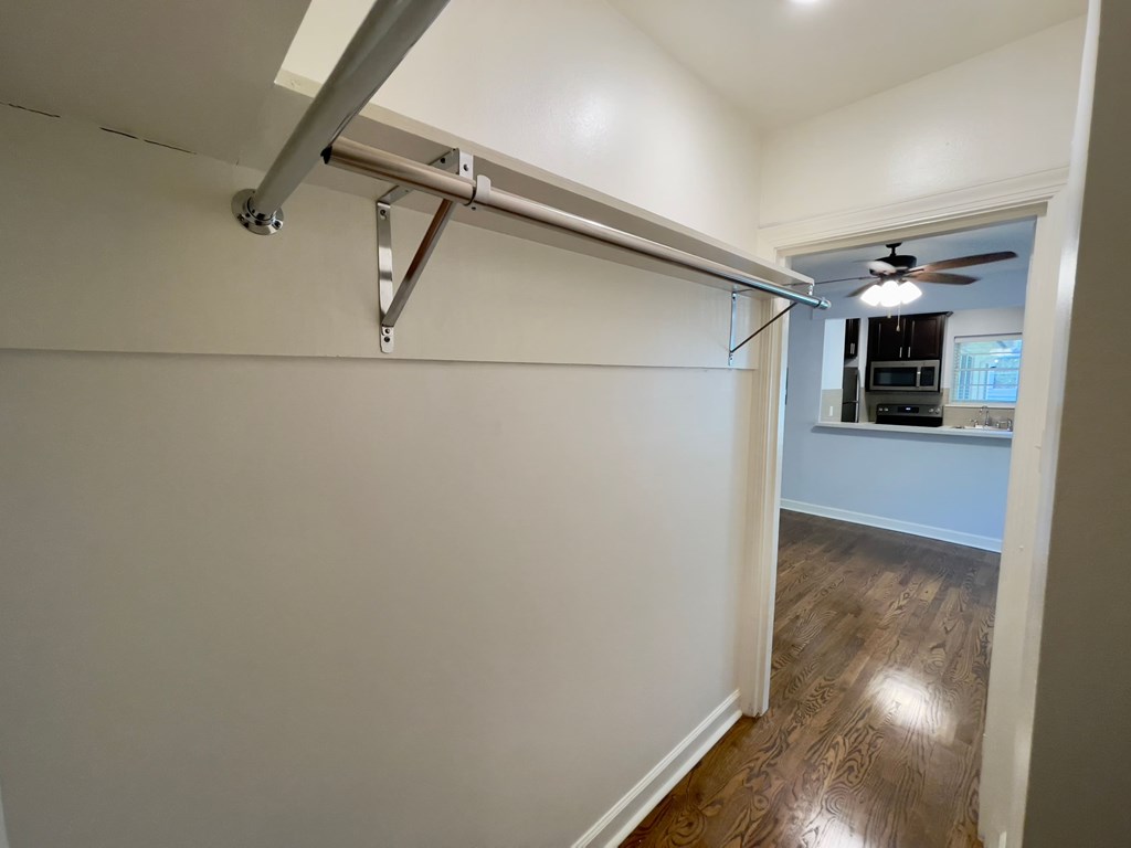 an empty living room with a white wall with a sliding door