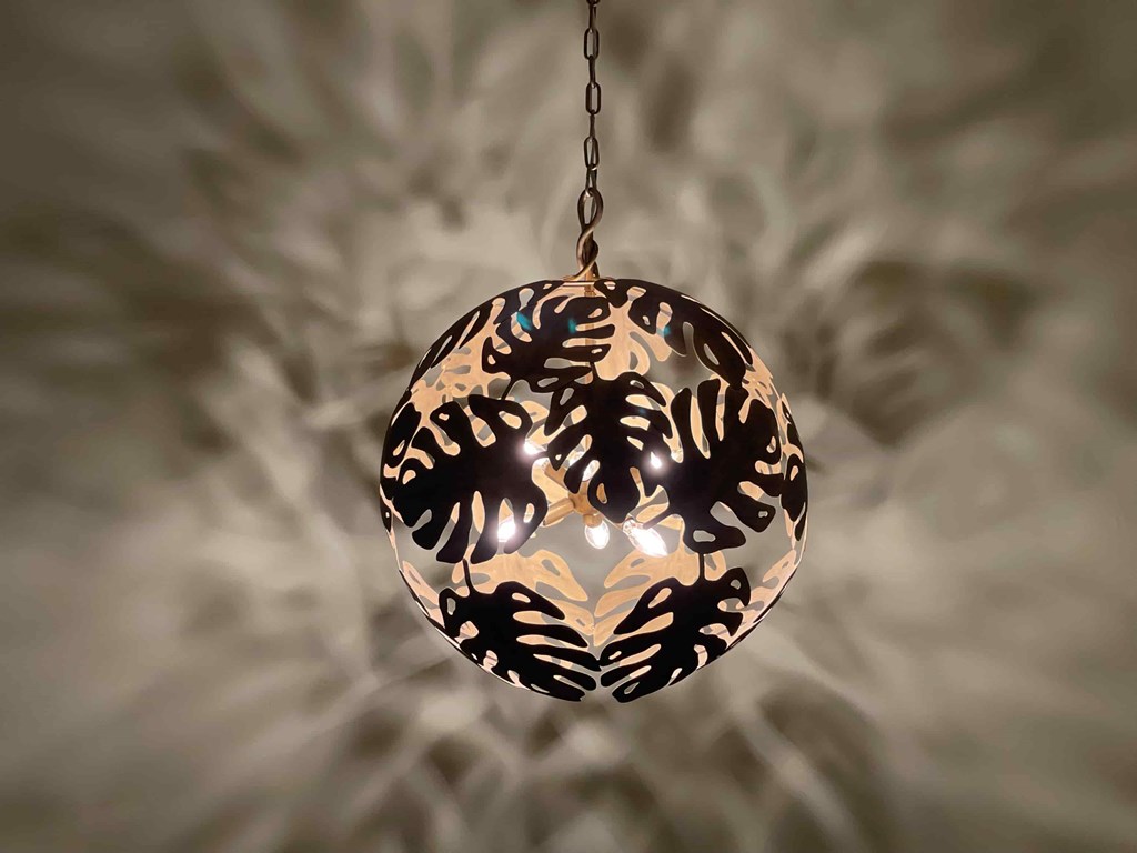 a pendant light in the shape of a tiger head on a chain