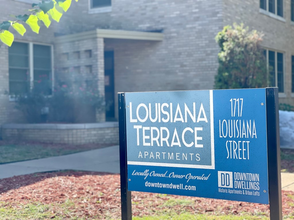 a sign in front of a house that says apartments