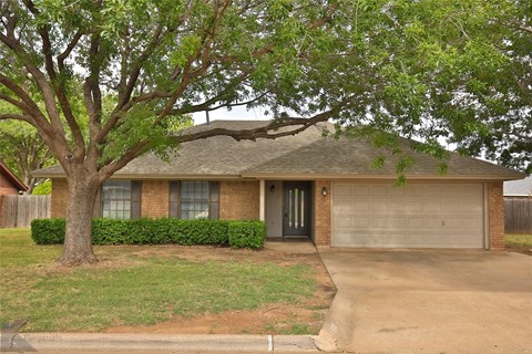 A house with a tree in front of it.