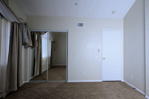 a living room with a mirror and a closet