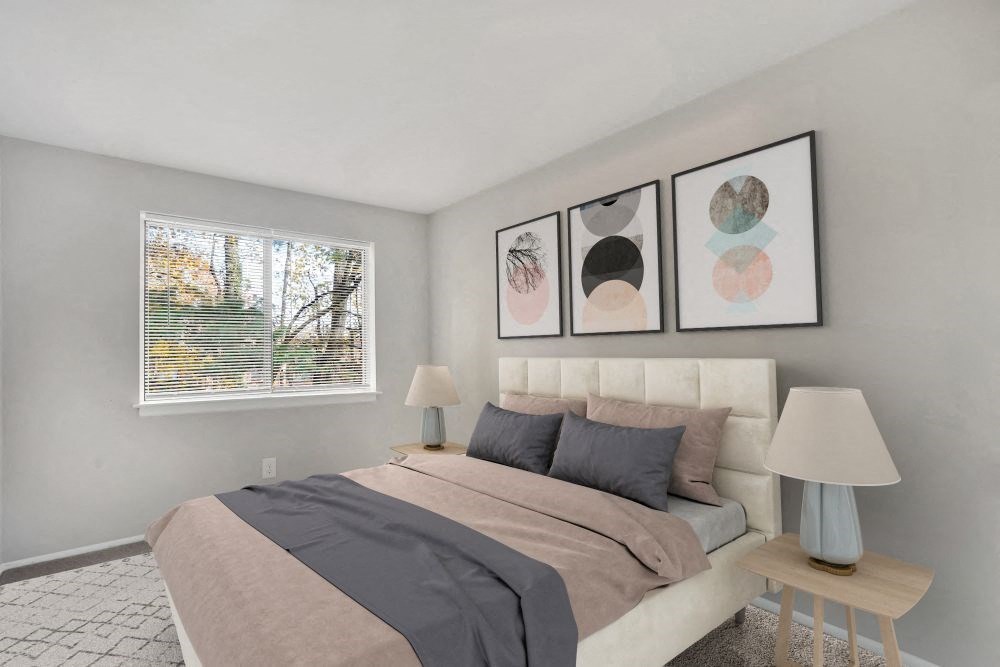 a bedroom with a bed and paintings on the wall